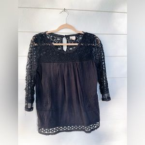 Anthropologie black top with lace detailing. Size small.